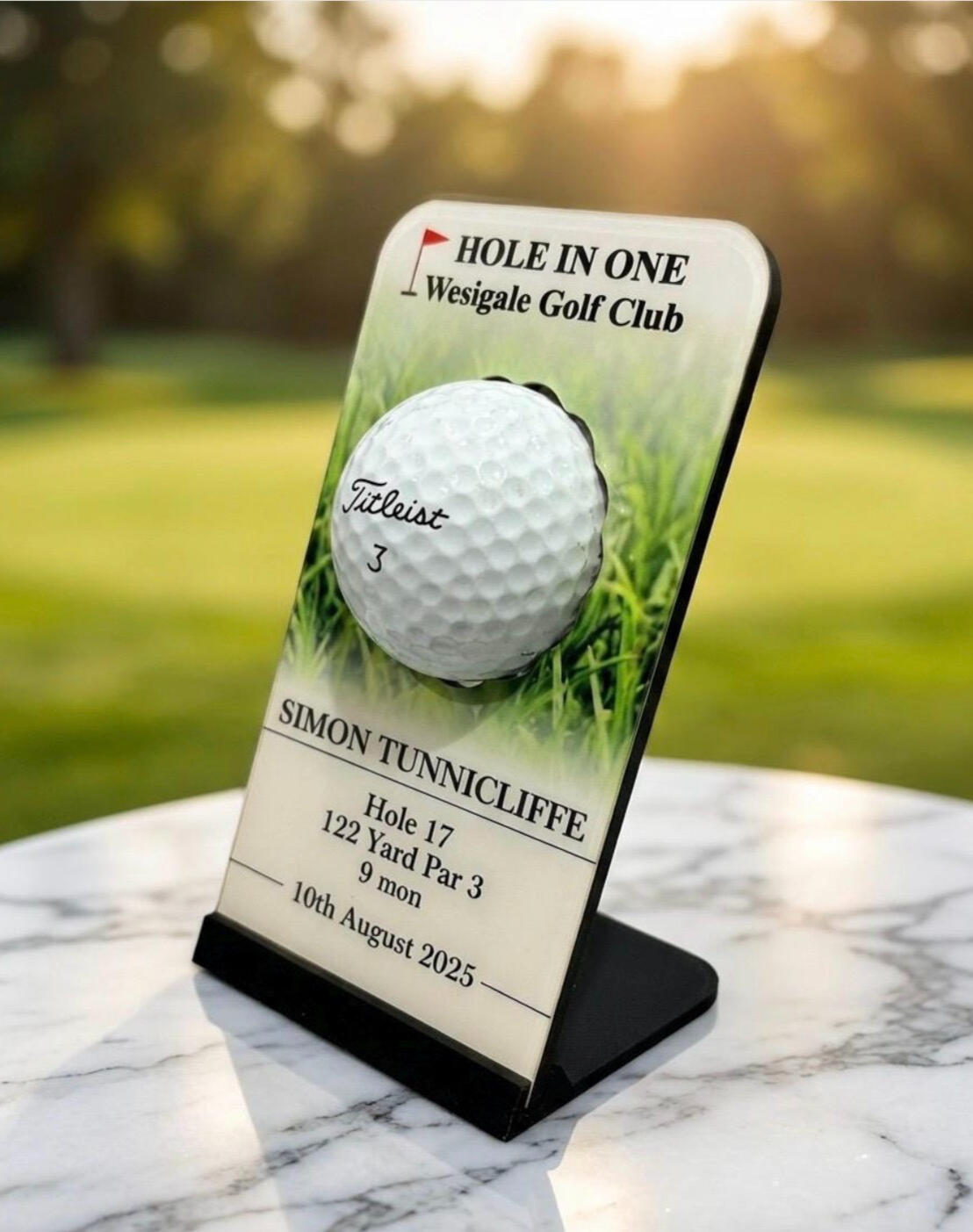 Sublimated plaque displaying a golf ball for a hole in one achievement. It stands on a 3d printed base